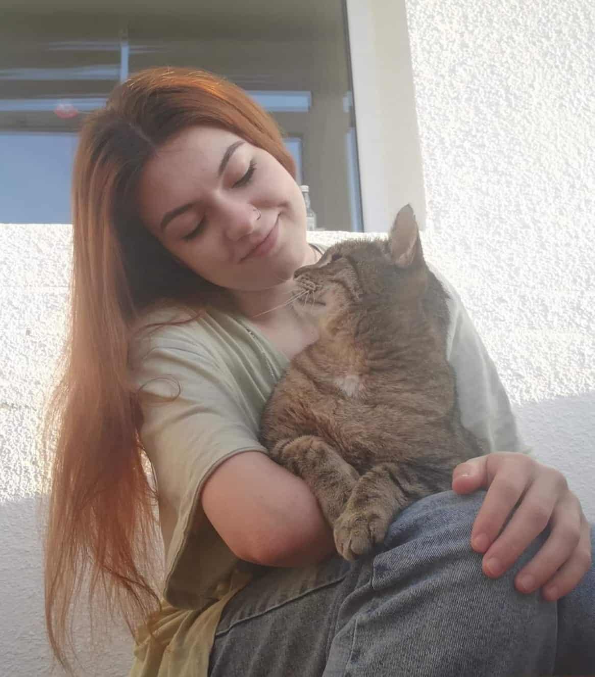 May be an image of 1 person and cat
